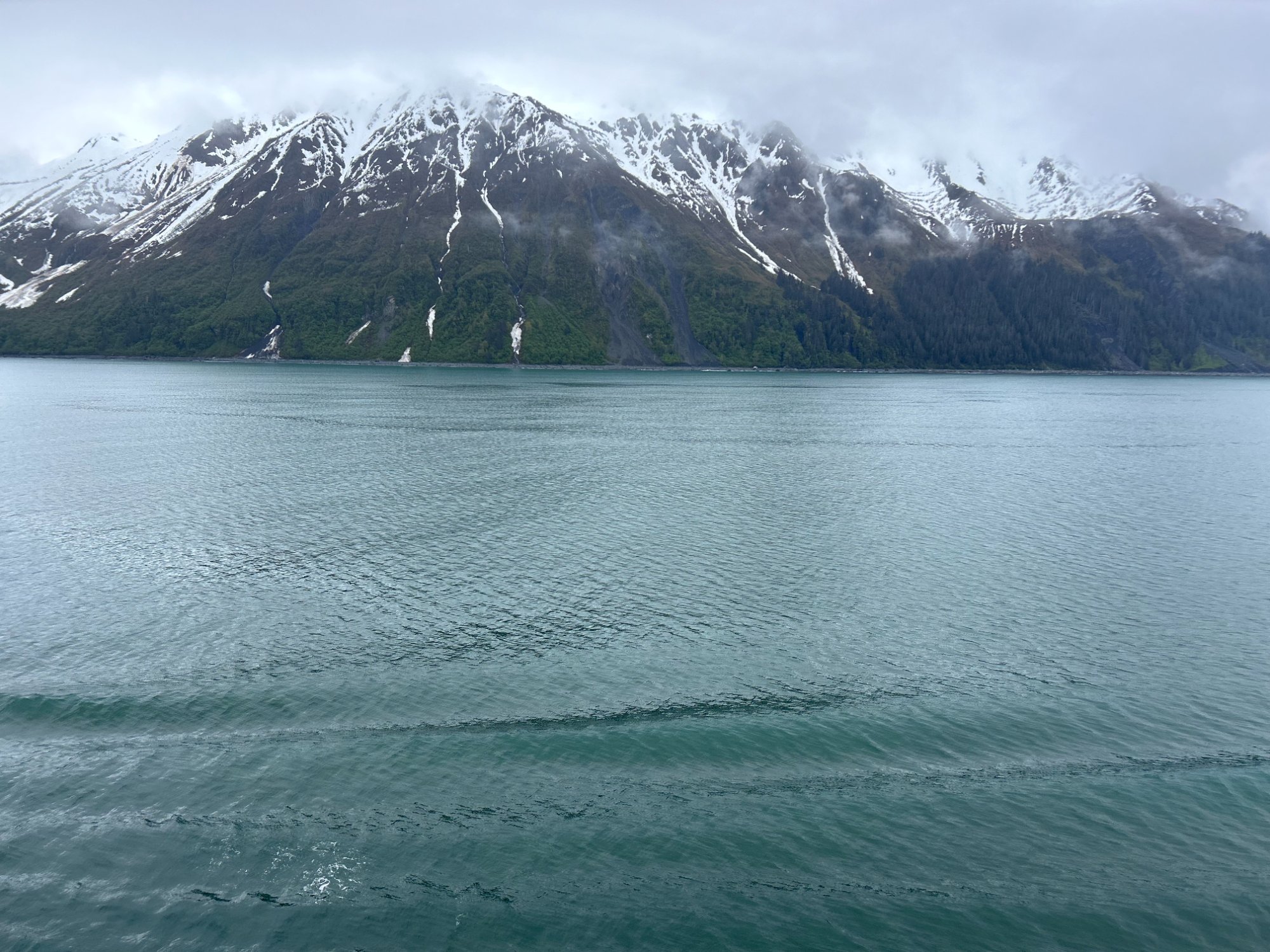 Alaska mountain peaks reflected in calm blue water