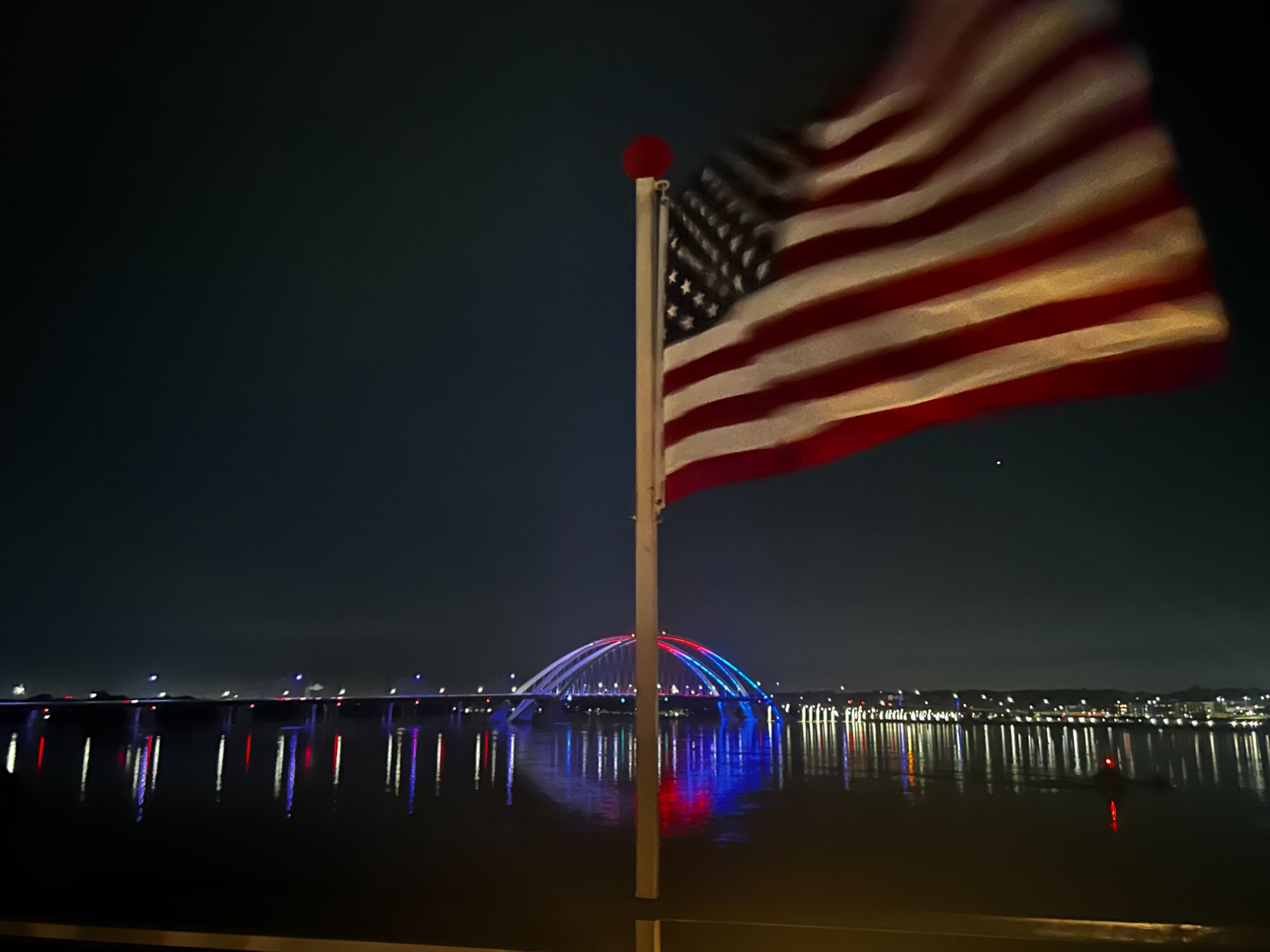 American flag flying on cruise ship deck at night